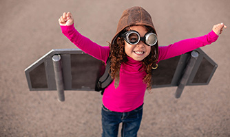 Young girl dressed in a rocket costume.