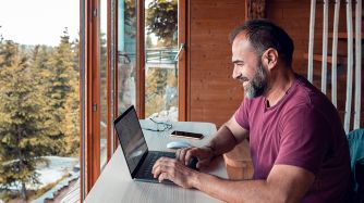 Man working on laptop computer.