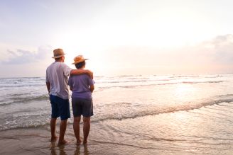 Couple walking on a beach.